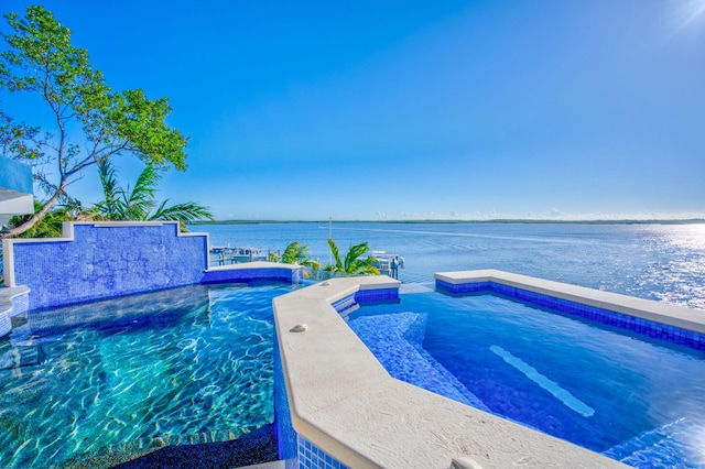 view of swimming pool with a water view