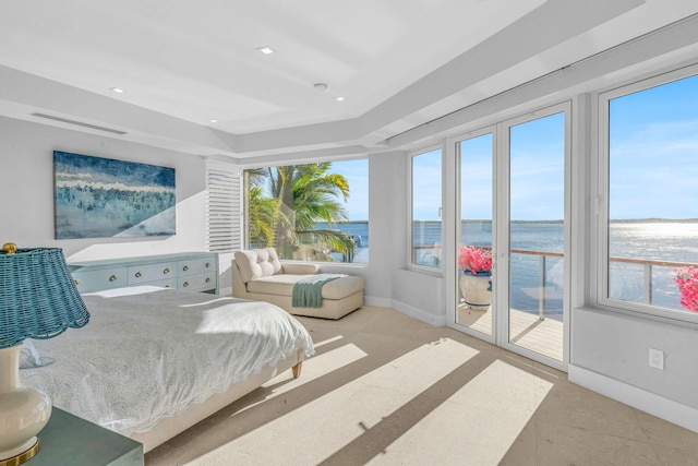 bedroom featuring access to exterior and a water view