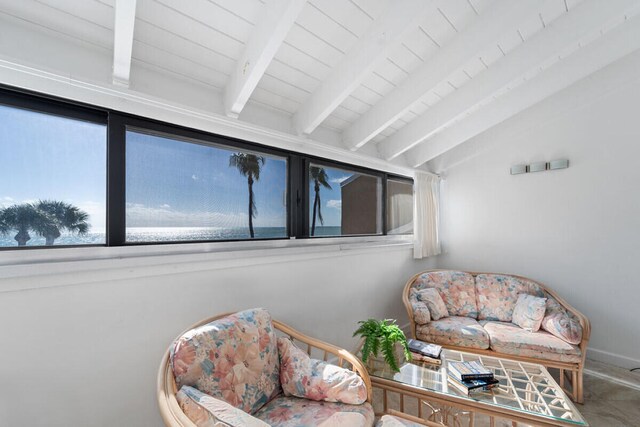 living area with vaulted ceiling with beams