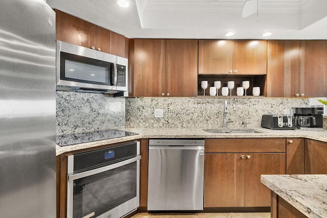 kitchen featuring sink, decorative backsplash, ornamental molding, light stone counters, and stainless steel appliances