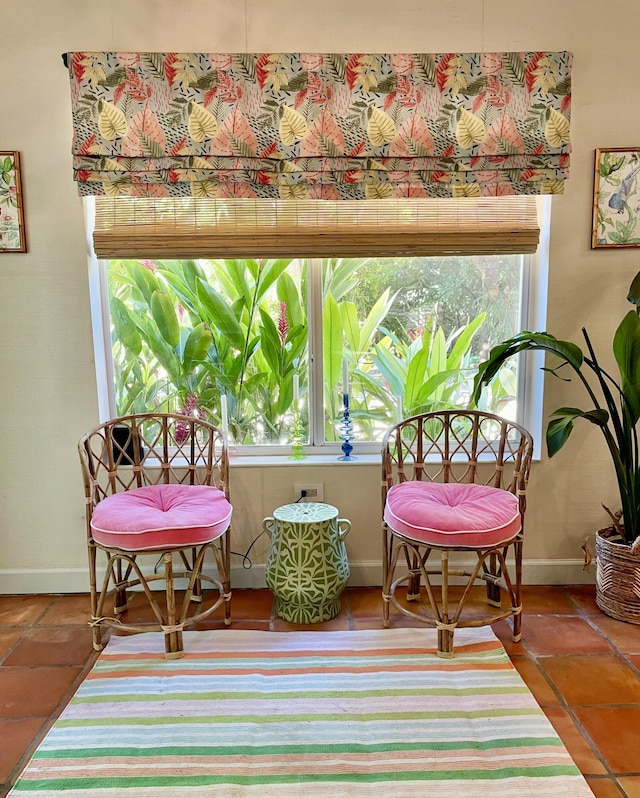 living area featuring baseboards and tile patterned floors