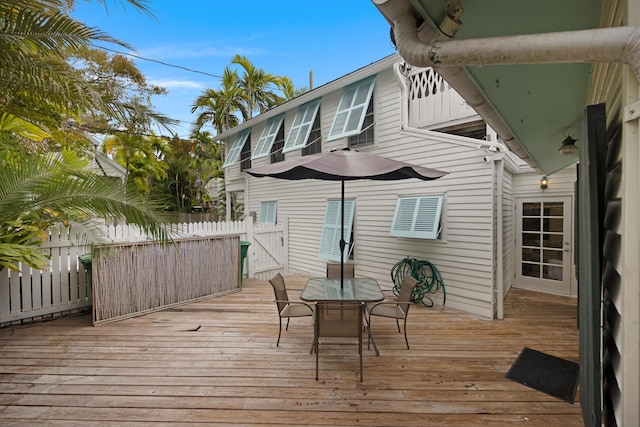 deck featuring outdoor dining space and fence