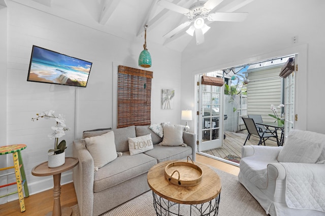 living room with lofted ceiling with beams, ceiling fan, and wood finished floors