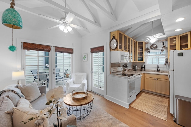 kitchen with glass insert cabinets, white appliances, a sink, and lofted ceiling with beams