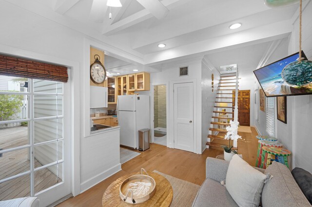 living area featuring light wood-style floors, visible vents, stairway, and recessed lighting