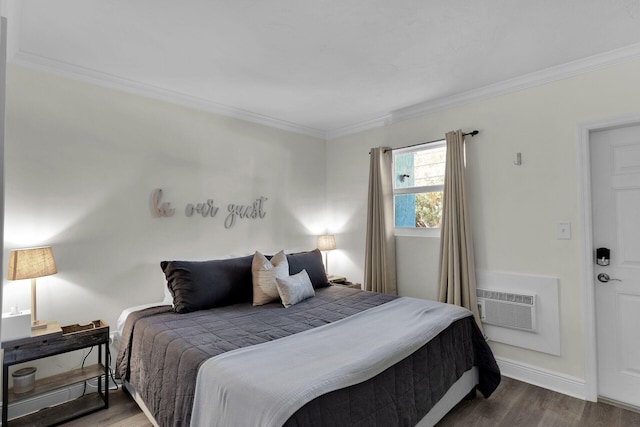 bedroom featuring a wall mounted air conditioner, baseboards, ornamental molding, and wood finished floors