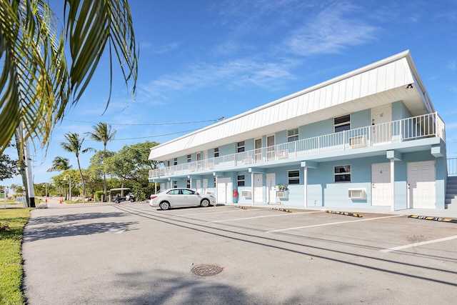 view of building exterior featuring uncovered parking