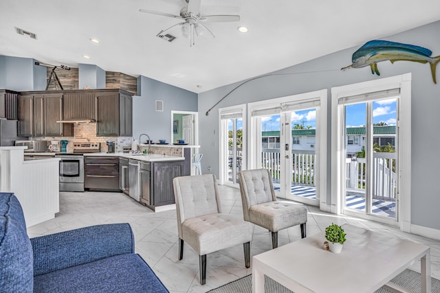 living area featuring visible vents, marble finish floor, ceiling fan, and vaulted ceiling