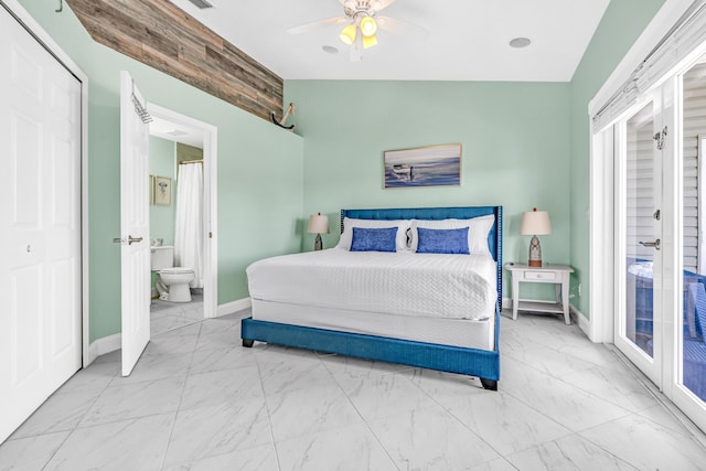 bedroom featuring ensuite bathroom, a ceiling fan, marble finish floor, and baseboards