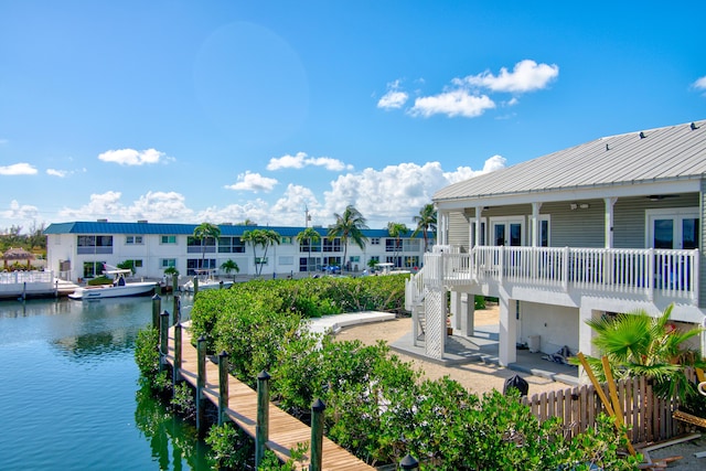 dock area with a water view and fence