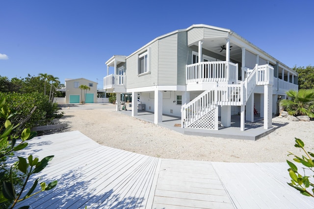 back of house with a patio, stairs, and ceiling fan