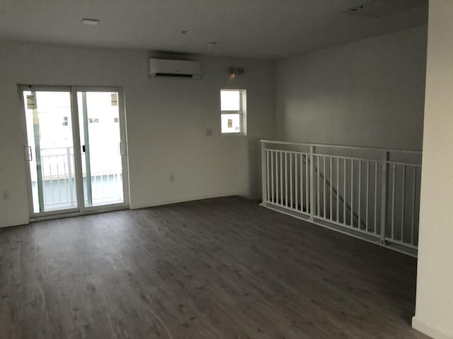 10877 Overseas Hwy Unit 85, Marathon, FL 33050 - empty room with a wall mounted AC and wood finished floors