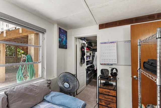 bedroom featuring light tile patterned floors and a closet