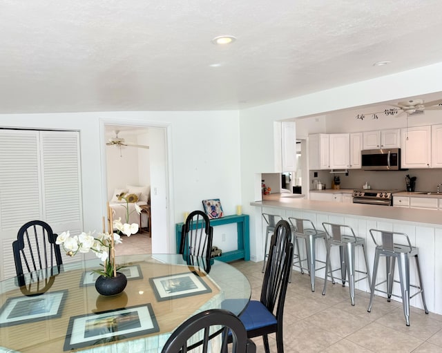 dining space with sink and light tile patterned floors