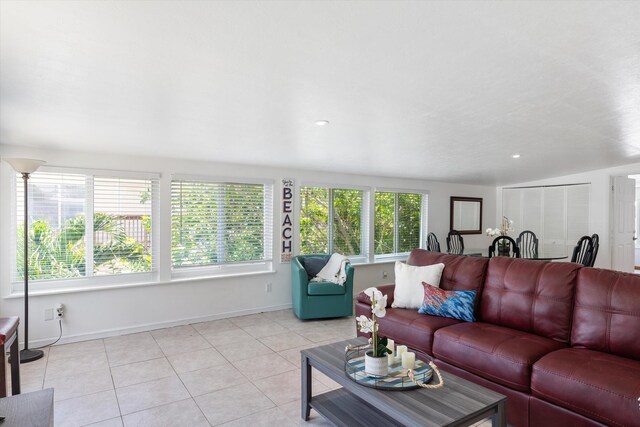 tiled living room featuring lofted ceiling