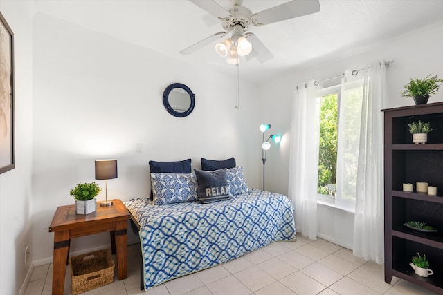 tiled bedroom featuring ceiling fan and multiple windows