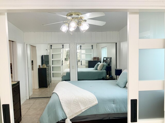 bedroom with light tile patterned floors and ceiling fan