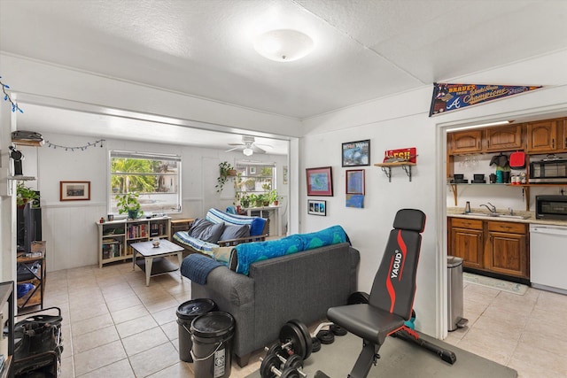 tiled living room with sink, a textured ceiling, and ceiling fan