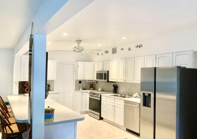 kitchen with ceiling fan, stainless steel appliances, sink, and white cabinets