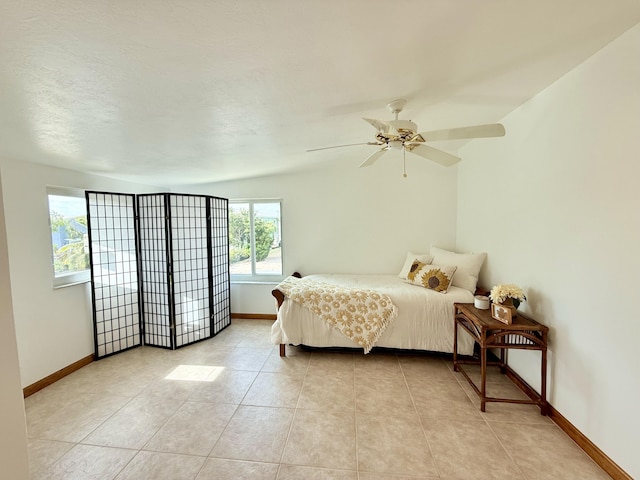 bedroom with light tile patterned floors and ceiling fan