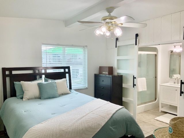 bedroom with ensuite bath, sink, light tile patterned floors, ceiling fan, and beam ceiling