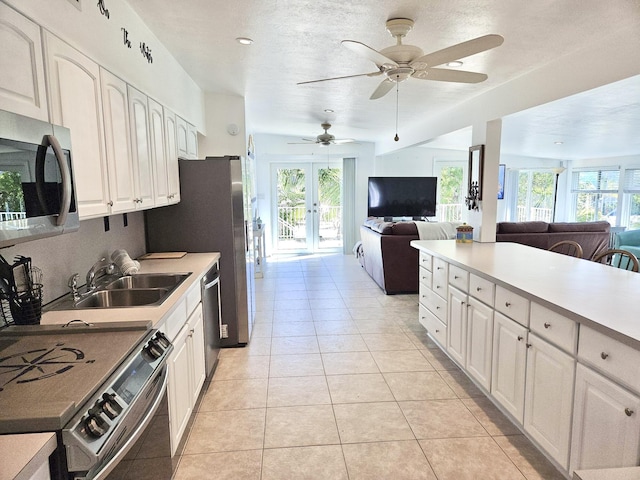 kitchen featuring white cabinetry, sink, a wealth of natural light, and appliances with stainless steel finishes