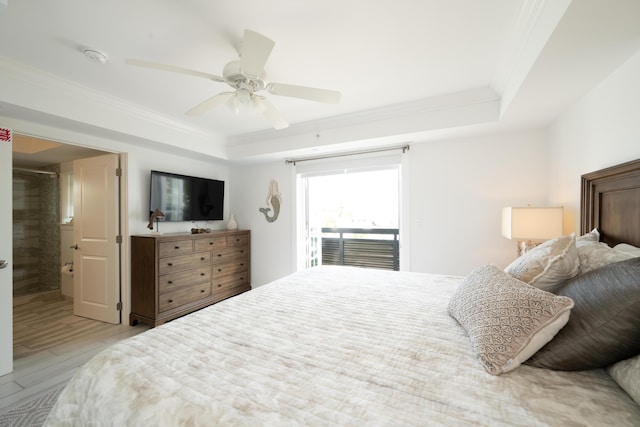 bedroom featuring a raised ceiling, ornamental molding, and access to outside