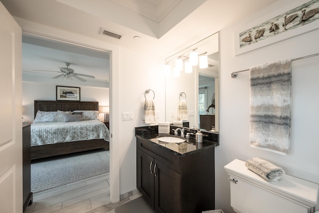 bathroom with vanity, hardwood / wood-style floors, toilet, and ceiling fan