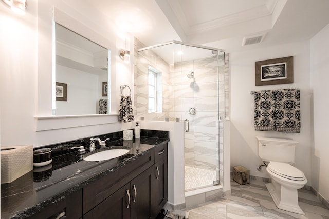 bathroom featuring a shower with door, ornamental molding, vanity, and toilet