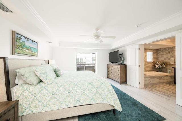 bedroom featuring crown molding, ceiling fan, connected bathroom, a tray ceiling, and light hardwood / wood-style floors