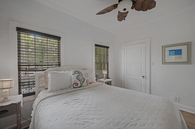 1025 Elgin Ln, Key West, FL 33040 - bedroom featuring multiple windows, crown molding, wood finished floors, baseboards, and a ceiling fan