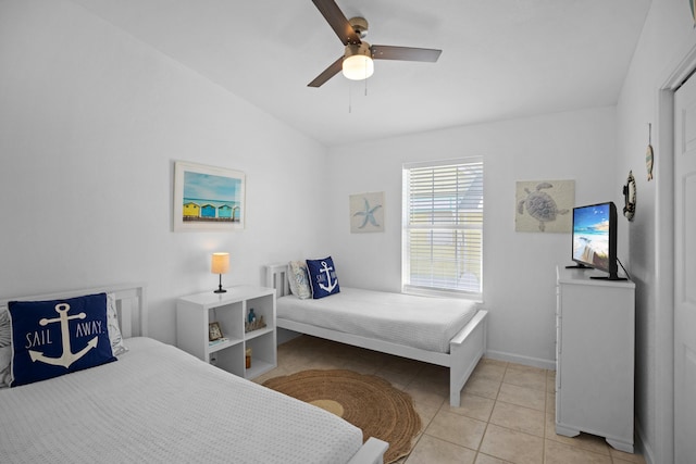 tiled bedroom featuring lofted ceiling and ceiling fan