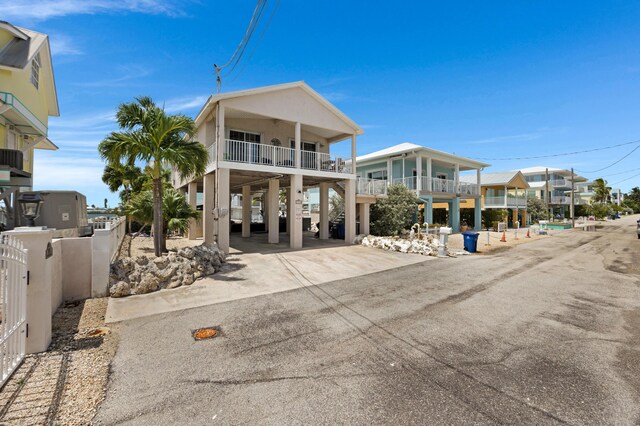 view of front of property featuring a carport and a balcony