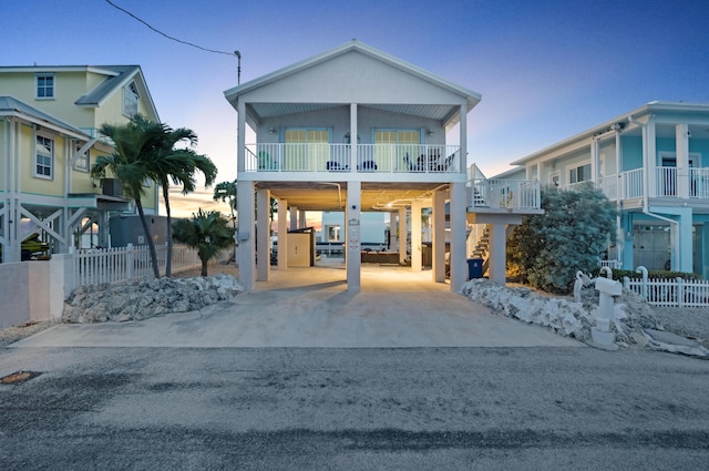 raised beach house with a carport and a balcony