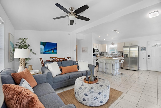 tiled living room featuring vaulted ceiling and ceiling fan