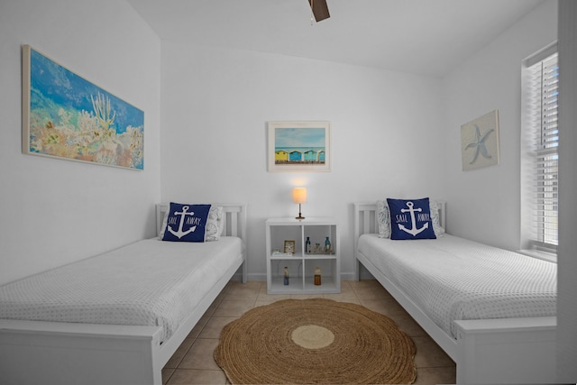 bedroom featuring multiple windows, light tile patterned floors, and ceiling fan