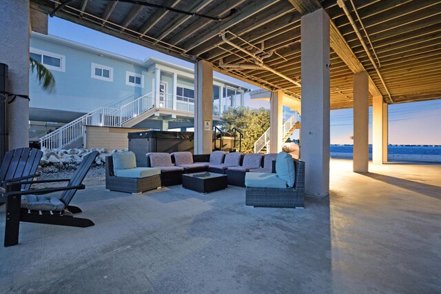 patio terrace at dusk with a hot tub and outdoor lounge area