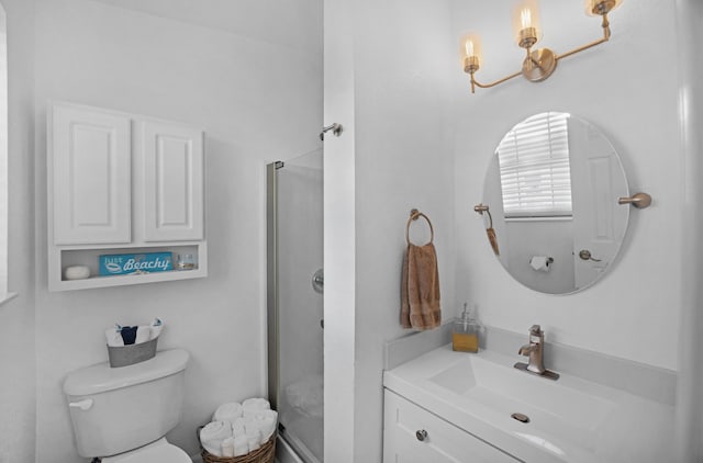 bathroom with vanity, a notable chandelier, and toilet