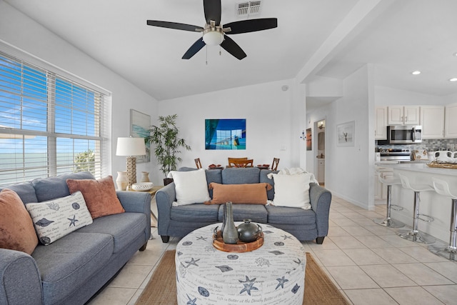 tiled living room with lofted ceiling and ceiling fan