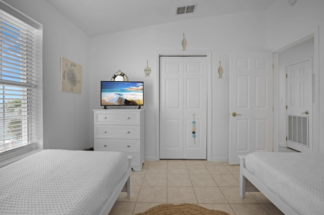 tiled bedroom featuring a closet