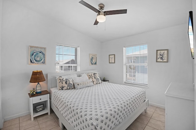 tiled bedroom featuring multiple windows, lofted ceiling, and ceiling fan