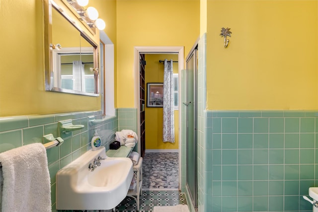 3608 Sunrise Dr, Key West, FL 33040 - full bathroom featuring tile walls, a shower stall, a sink, and a wainscoted wall
