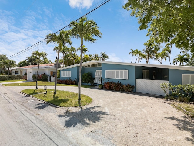 3608 Sunrise Dr, Key West, FL 33040 - view of front of home featuring curved driveway, stucco siding, and a front yard