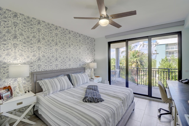 bedroom featuring access to outside, ceiling fan, an accent wall, and wallpapered walls