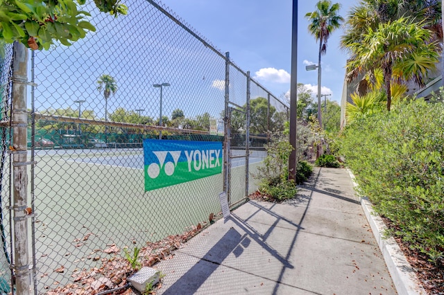 view of sport court featuring a gate and fence