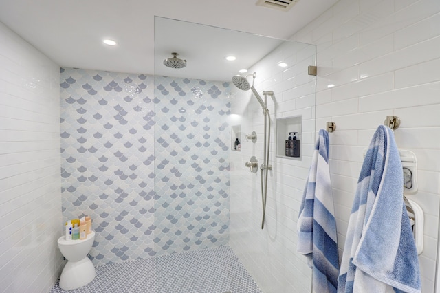 bathroom featuring tile patterned flooring, recessed lighting, tiled shower, and toilet