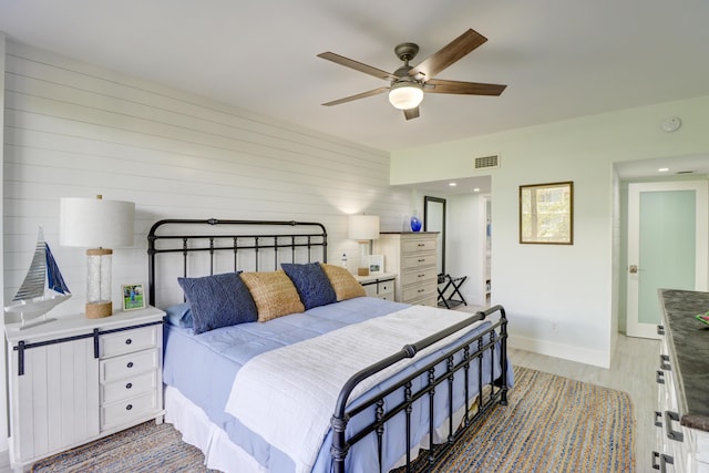 bedroom with visible vents, baseboards, light wood-style floors, and a ceiling fan