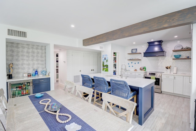 dining room featuring recessed lighting, visible vents, beam ceiling, and wet bar