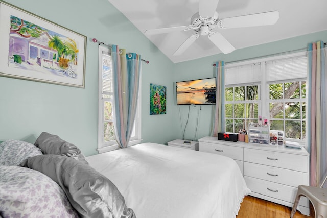 bedroom with lofted ceiling, light wood-type flooring, and ceiling fan