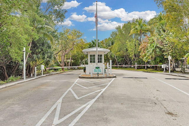 exterior space featuring curbs and a gated entry